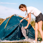 Camper zipping up an unstuck tent zipper