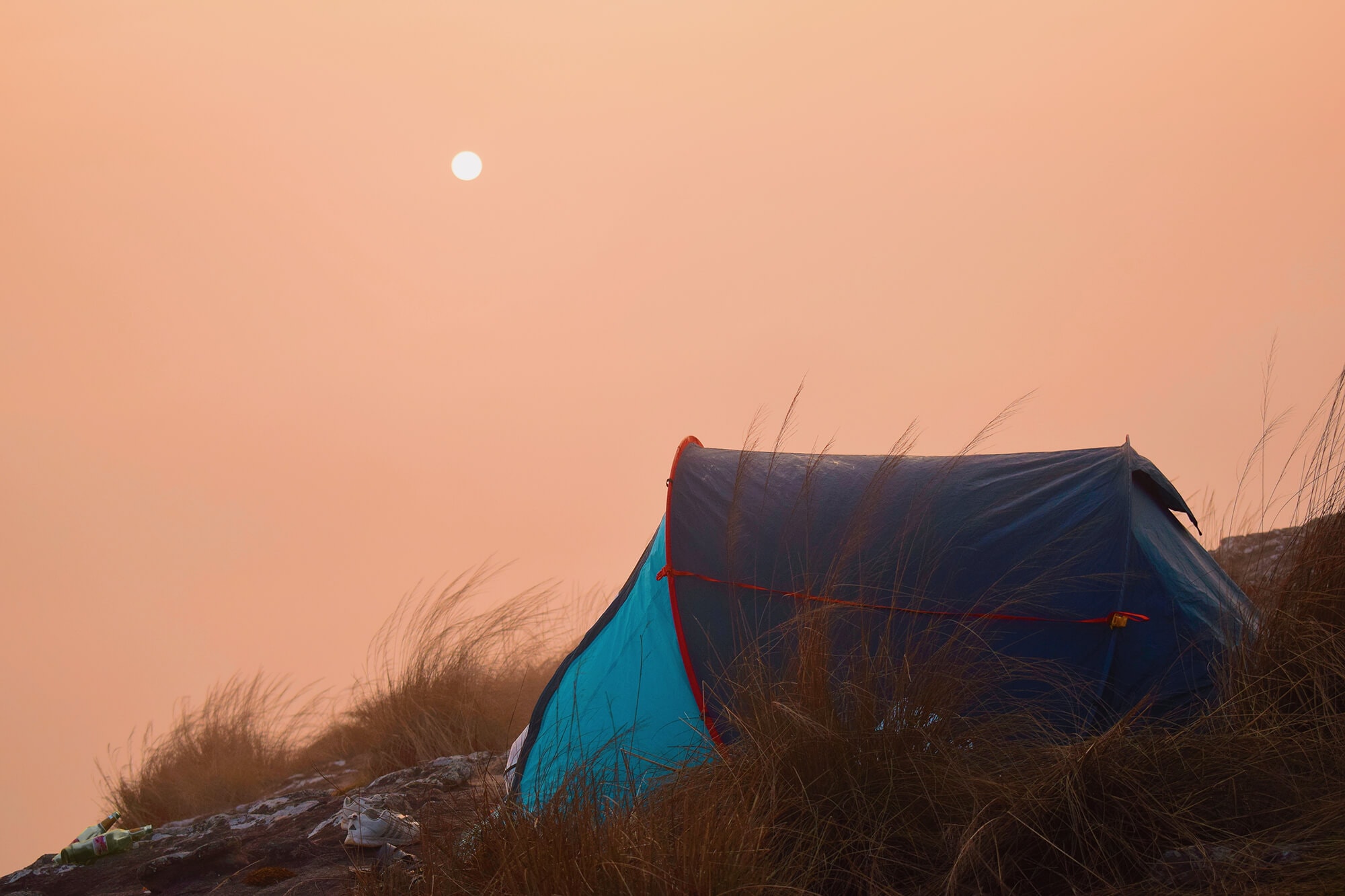 Dark Blackout Tent against the backdrop of a misty sky that is heating up
