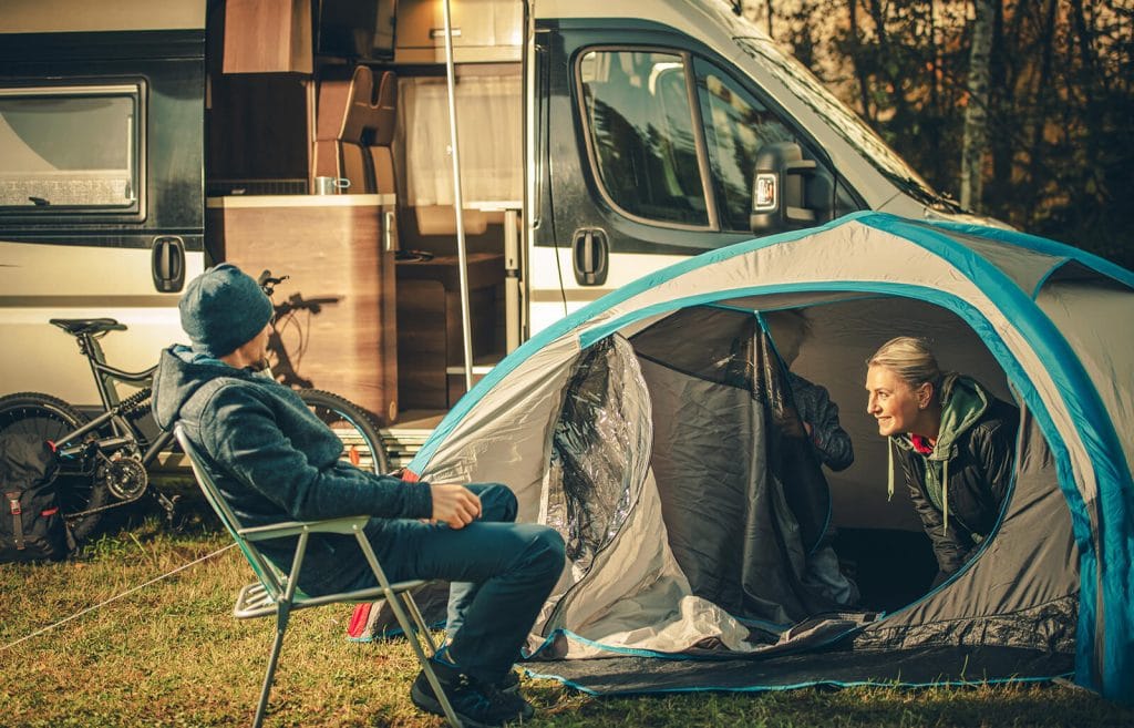 Family-camping-with-grey-blue-instant-tent-with-camper
