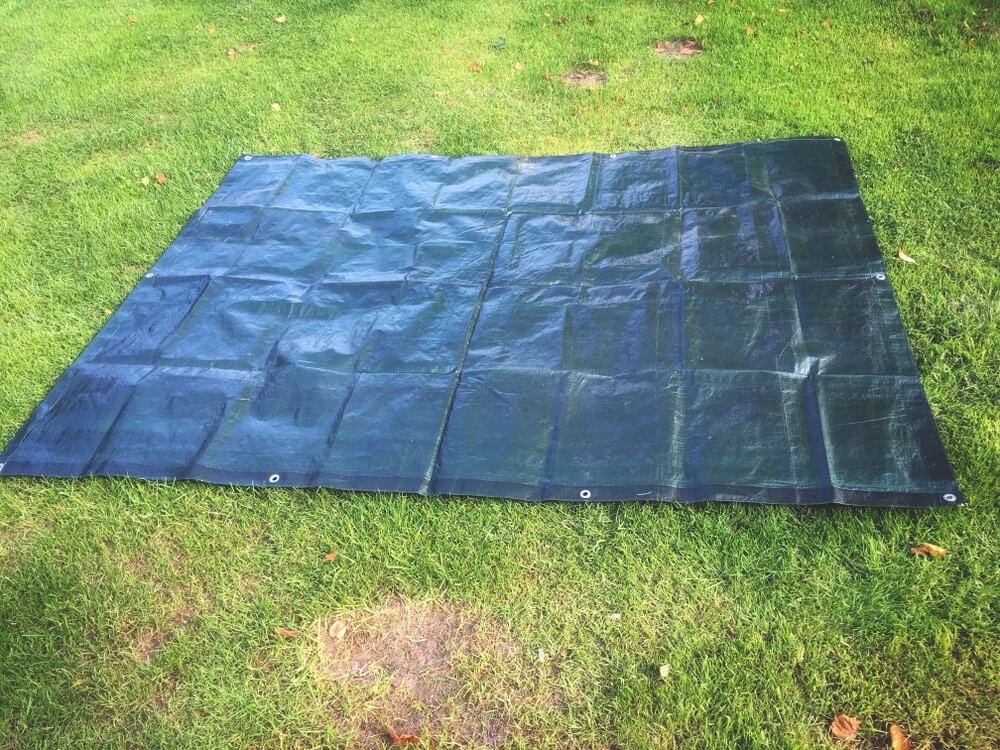 Green tarp laying down for tent