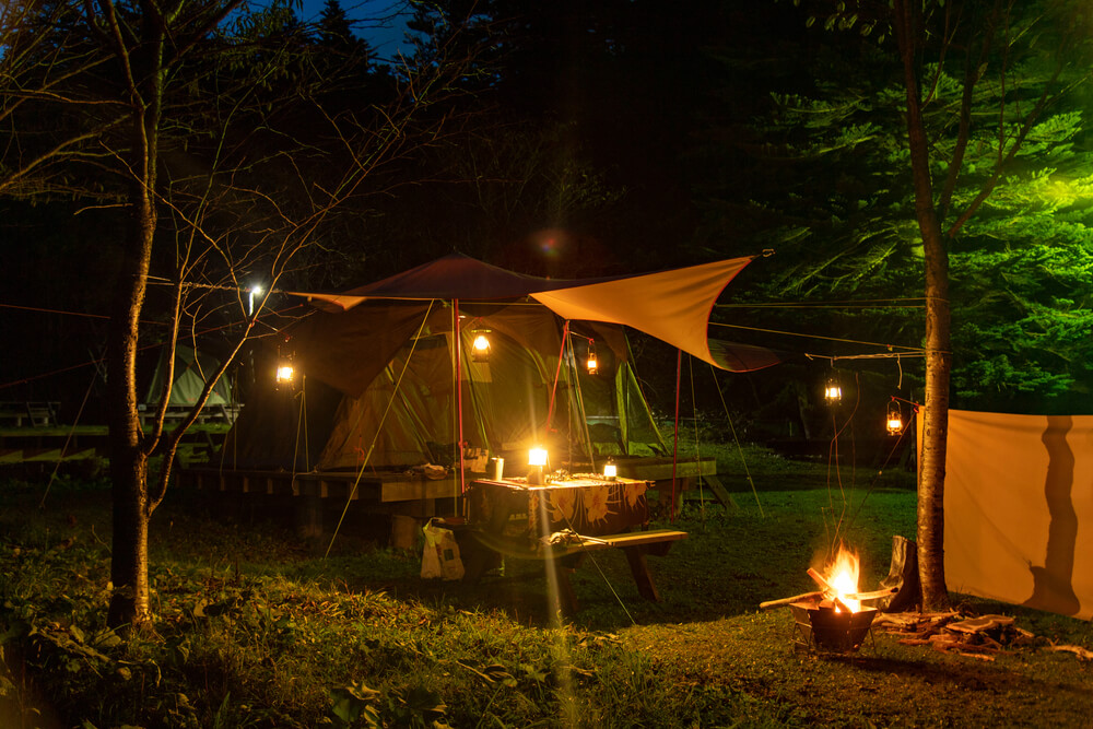 Illuminated campsite with candles