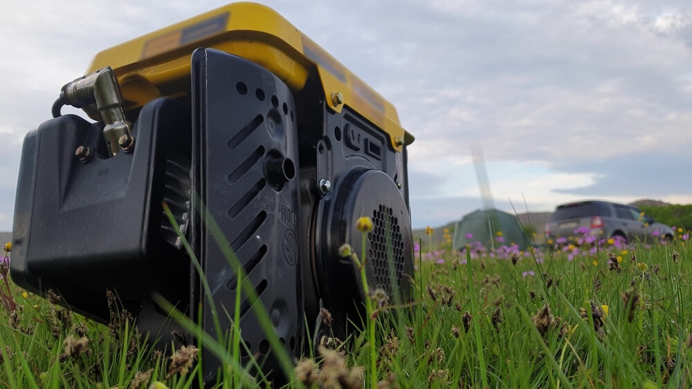 Petrlo generator on grass in front on campervan