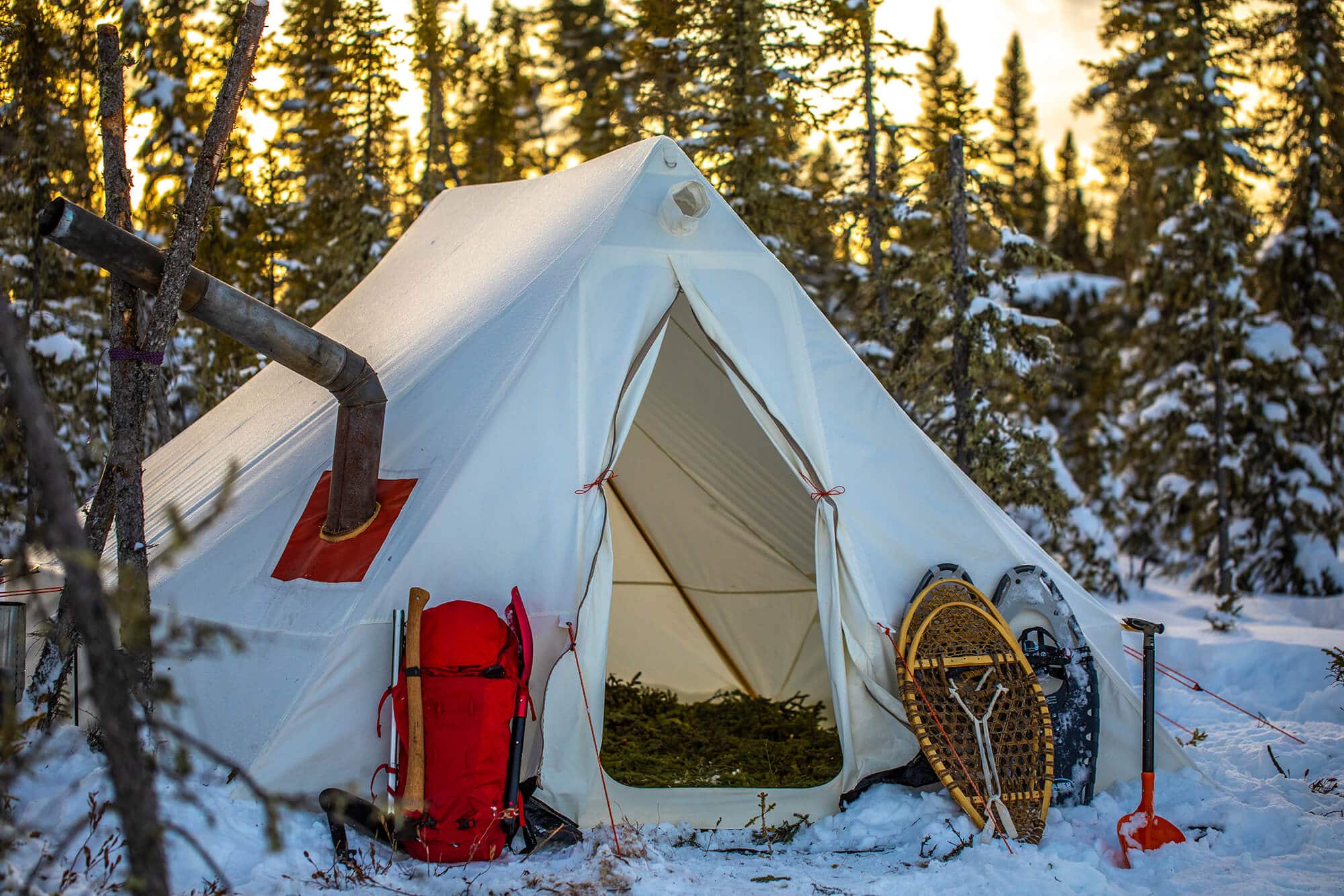 Tent with stove jack in the middle of freezing snow conditions