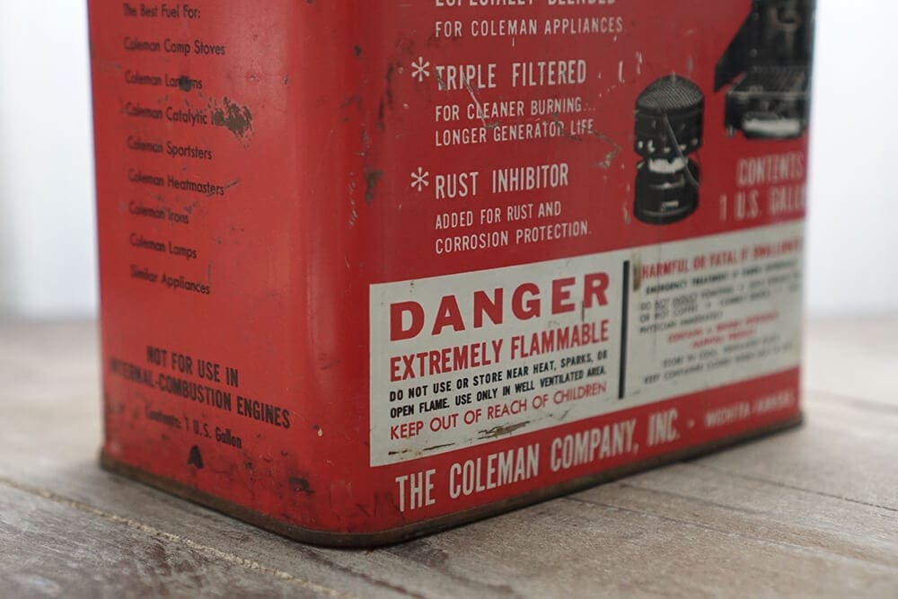 Vintage coleman red fuel tin battered showing warning labels